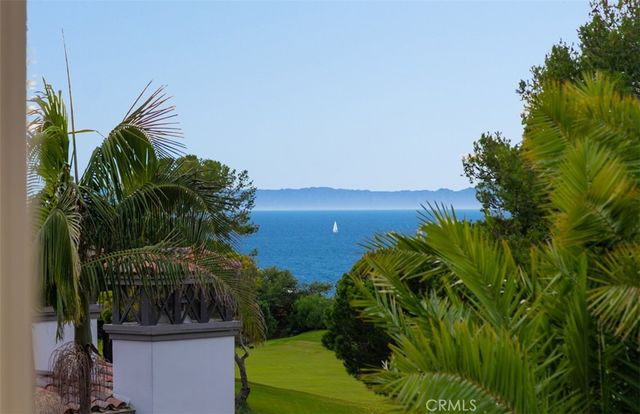 a bedroom with furniture and a large window