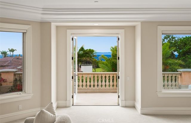a living room with furniture a mirror and a chandelier