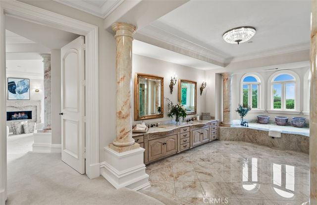 a living room with patio furniture and a chandelier