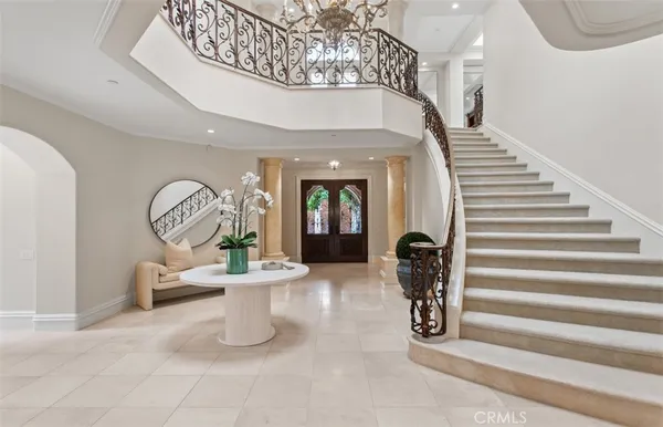 a view of staircase with a table and a chandelier