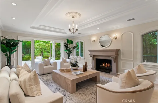 a view of a dining room with furniture and a chandelier
