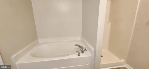 a white bath tub and shower