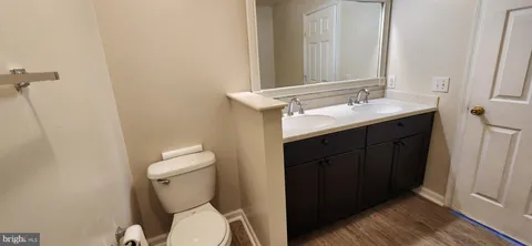 a bathroom with a sink mirror vanity and toilet