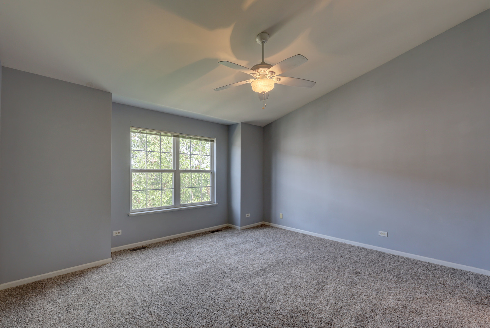 469 George Street Wood Dale, IL 60191 - Photo 18 of 24 an empty room with a window and a fan