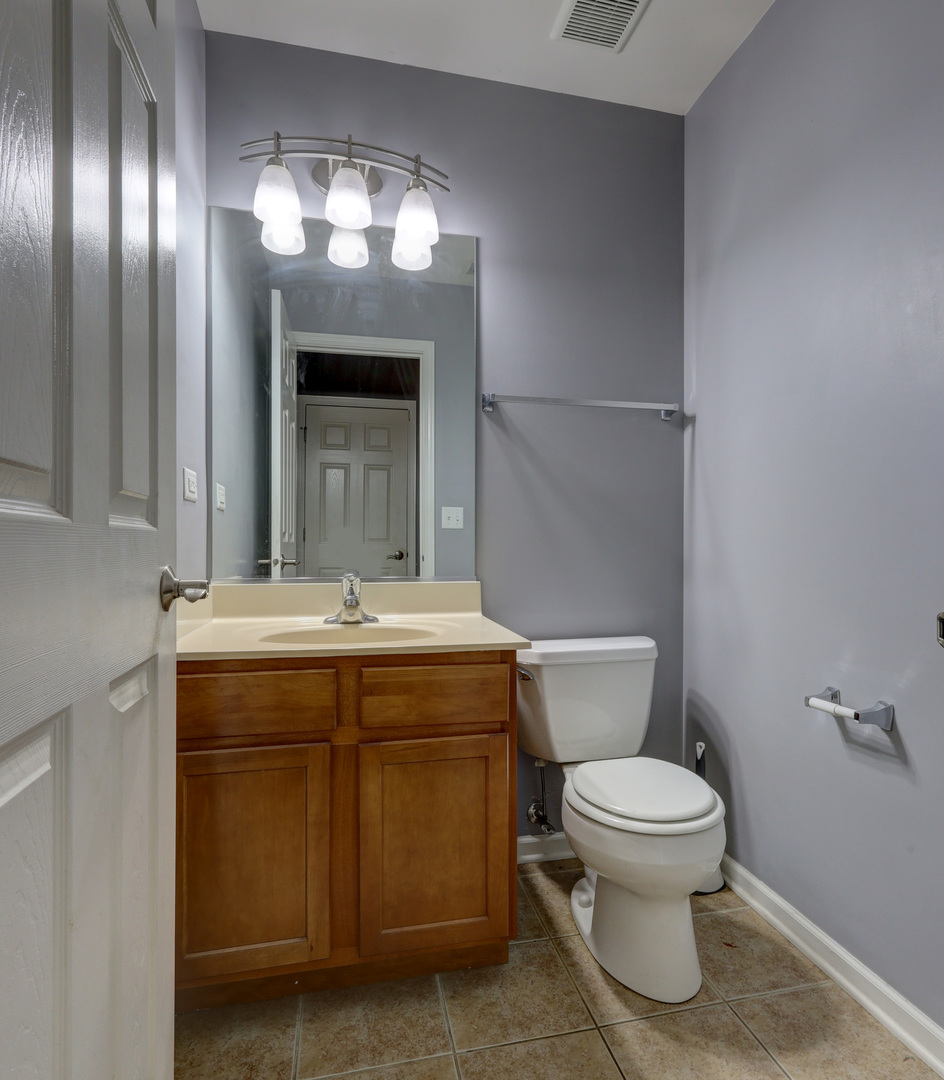469 George Street Wood Dale, IL 60191 - Photo 22 of 24 a bathroom with a toilet sink and mirror