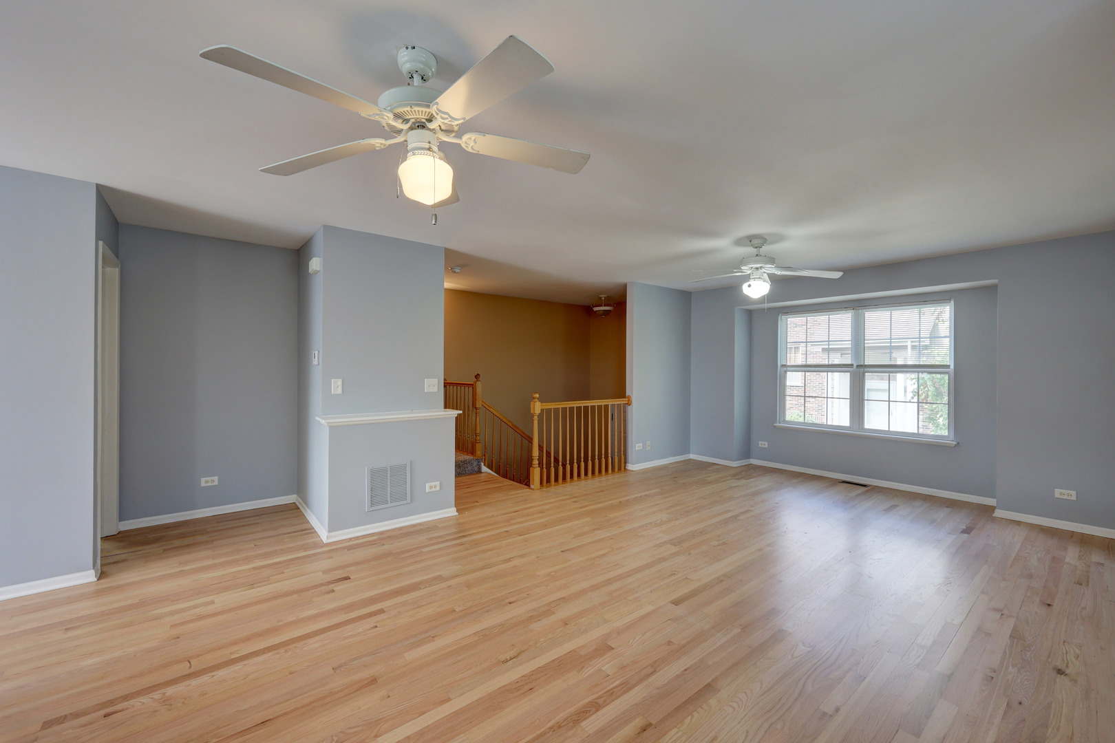 469 George Street Wood Dale, IL 60191 - Photo 3 of 24 a view of an empty room with a window and wooden floor