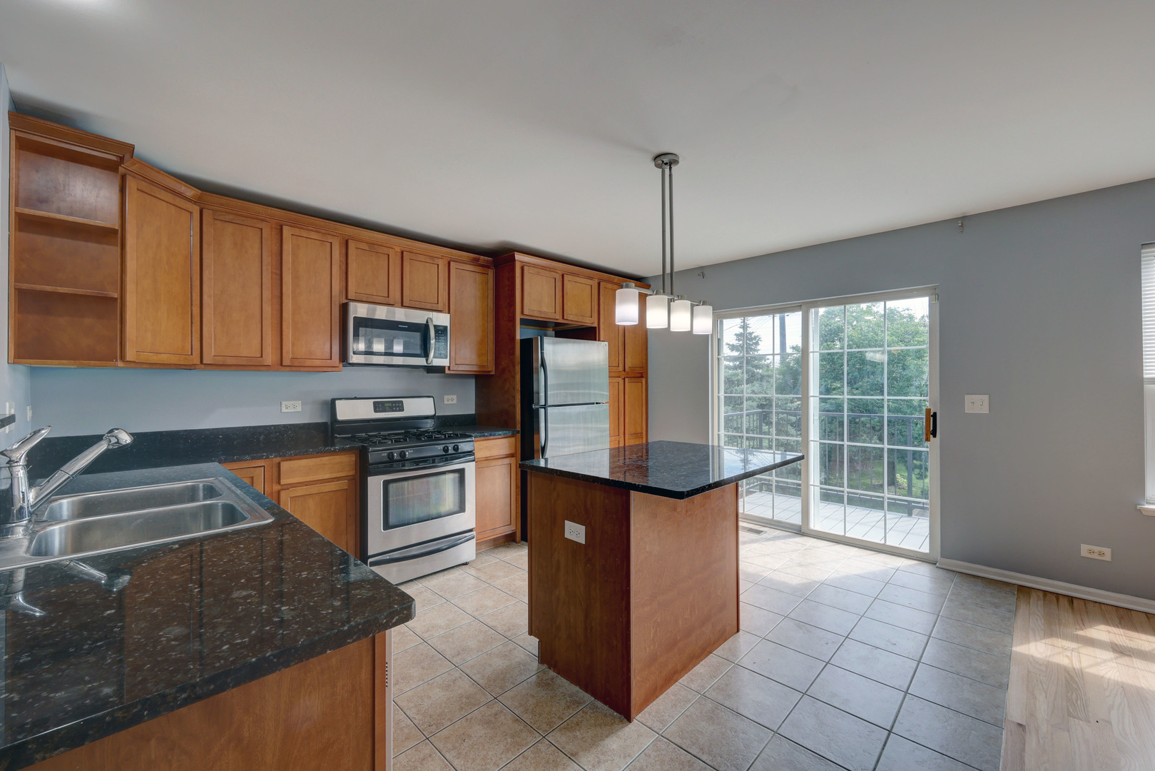 469 George Street Wood Dale, IL 60191 - Photo 6 of 24 a kitchen with stainless steel appliances granite countertop a stove a sink and a microwave