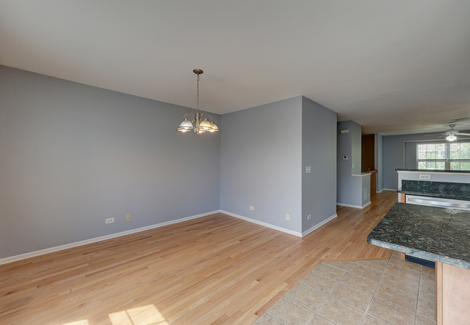 469 George Street Wood Dale, IL 60191 - Photo 8 of 24 a view of a livingroom with wooden floor and kitchen space