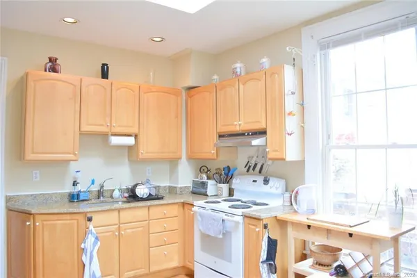 a kitchen with a sink stove and cabinets