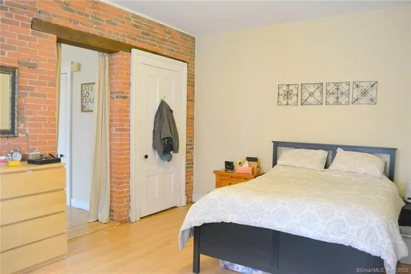 a bedroom with a bed and a dresser