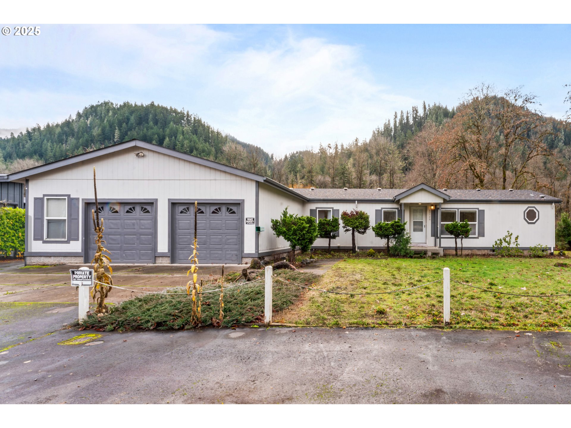47520 Perkins Street Oakridge, OR 97463 - Photo 1 of 44 a front view of a house with a yard table and chairs