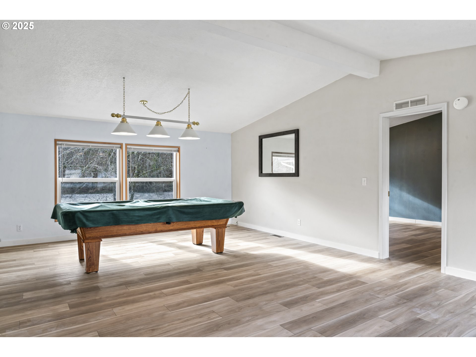 47520 Perkins Street Oakridge, OR 97463 - Photo 11 of 44 a view of room with wooden floor wooden floor and windows