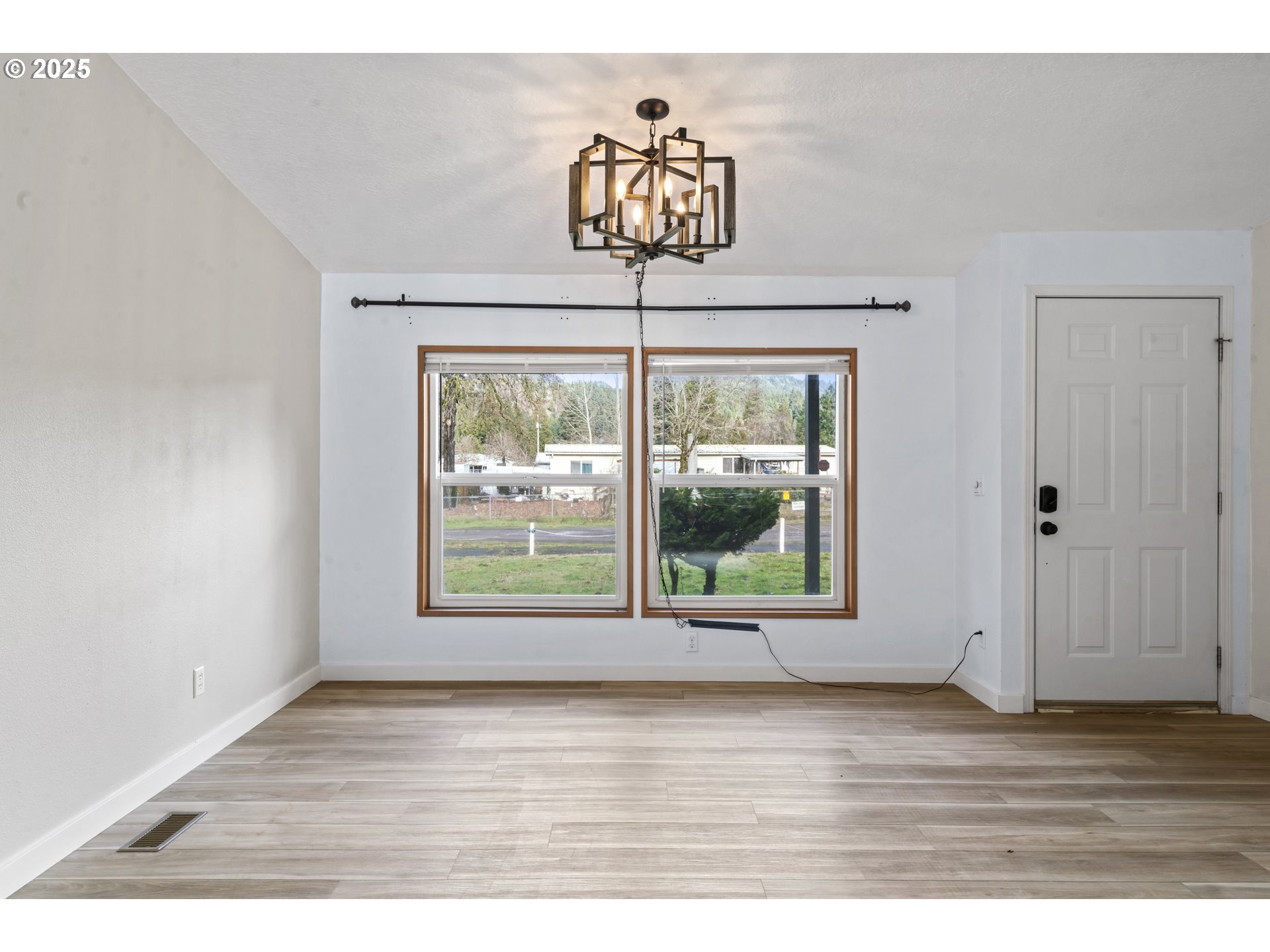 47520 Perkins Street Oakridge, OR 97463 - Photo 16 of 44 a view of an empty room with wooden floor and a window