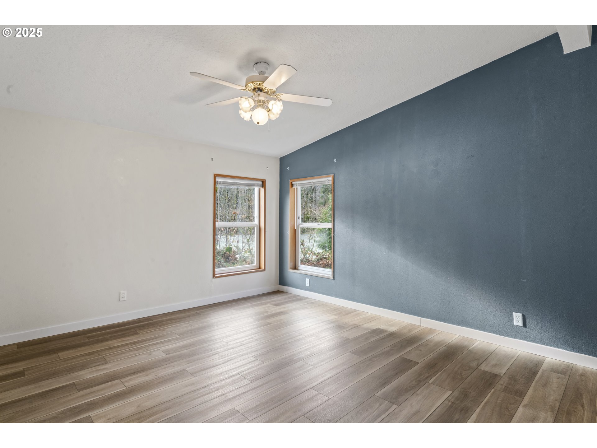 47520 Perkins Street Oakridge, OR 97463 - Photo 6 of 44 a view of an empty room with wooden floor and a window