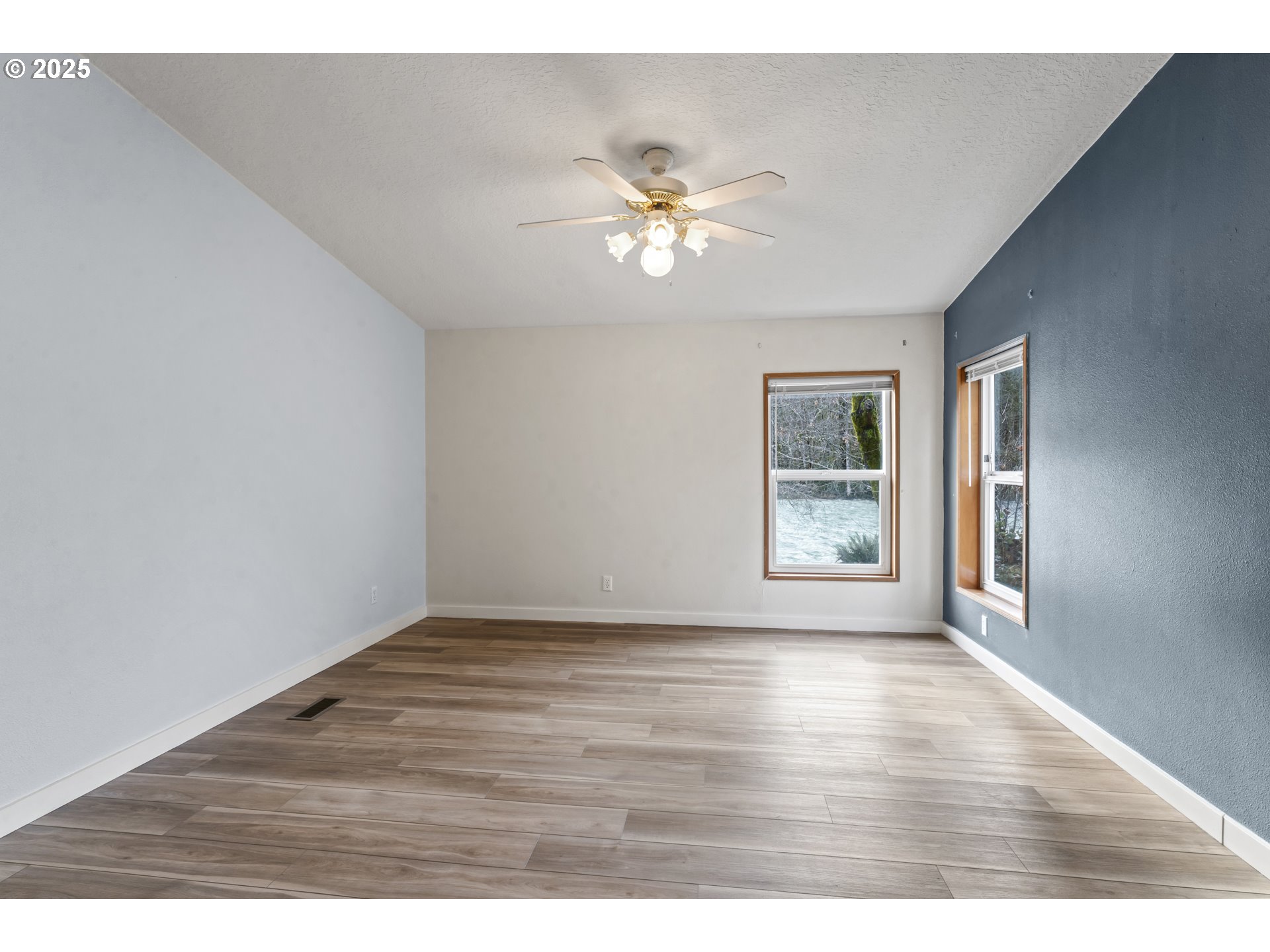 47520 Perkins Street Oakridge, OR 97463 - Photo 8 of 44 a view of an empty room with wooden floor and a window