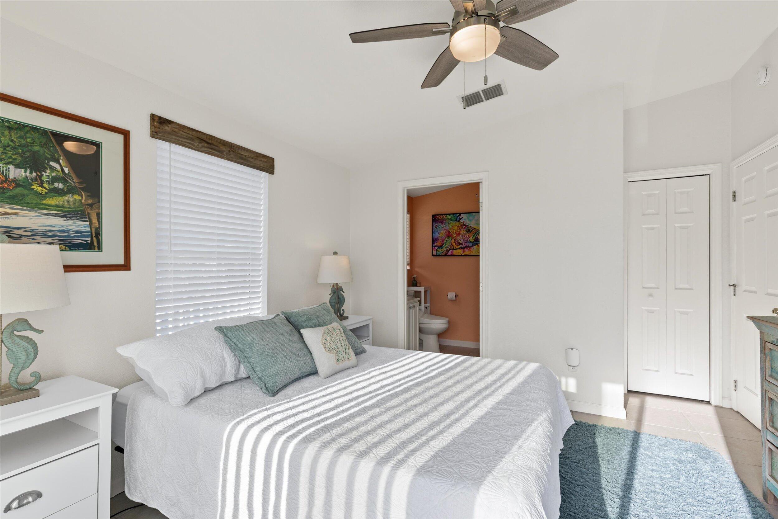 157 Mars Lane Key West, FL 33040 - Photo 22 of 41 a bedroom with a bed and a chandelier