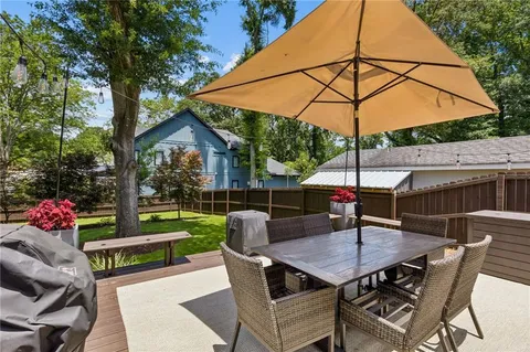 a view of a house with backyard and sitting area
