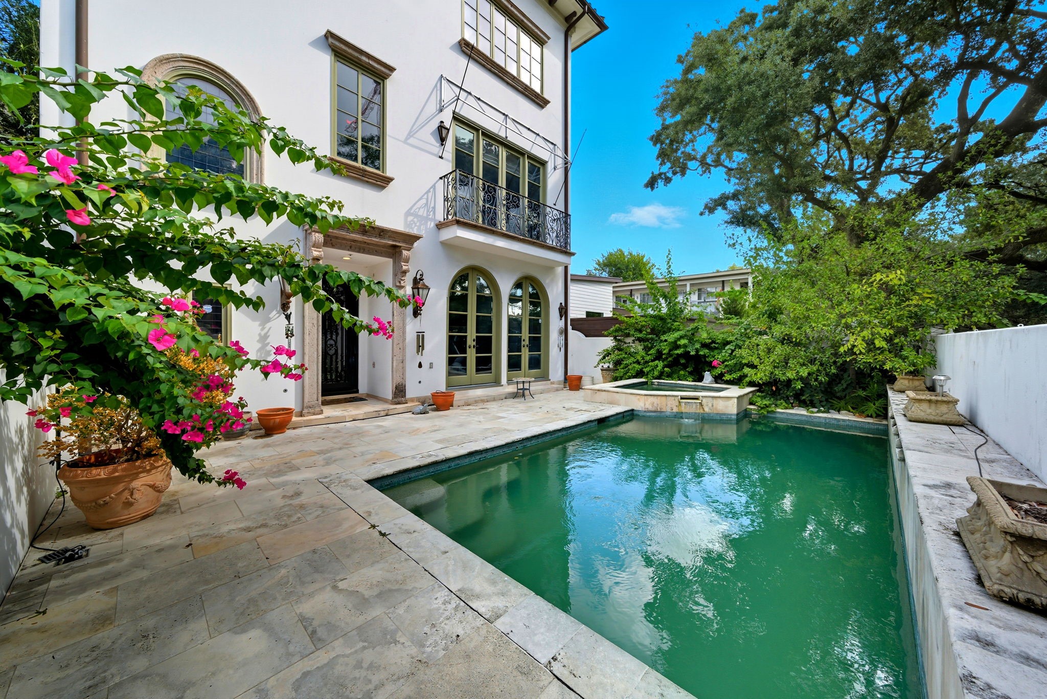 2370 Bolsover Street Houston, TX 77005 - Photo 3 of 46 a view of a swimming pool with potted plants and a bench