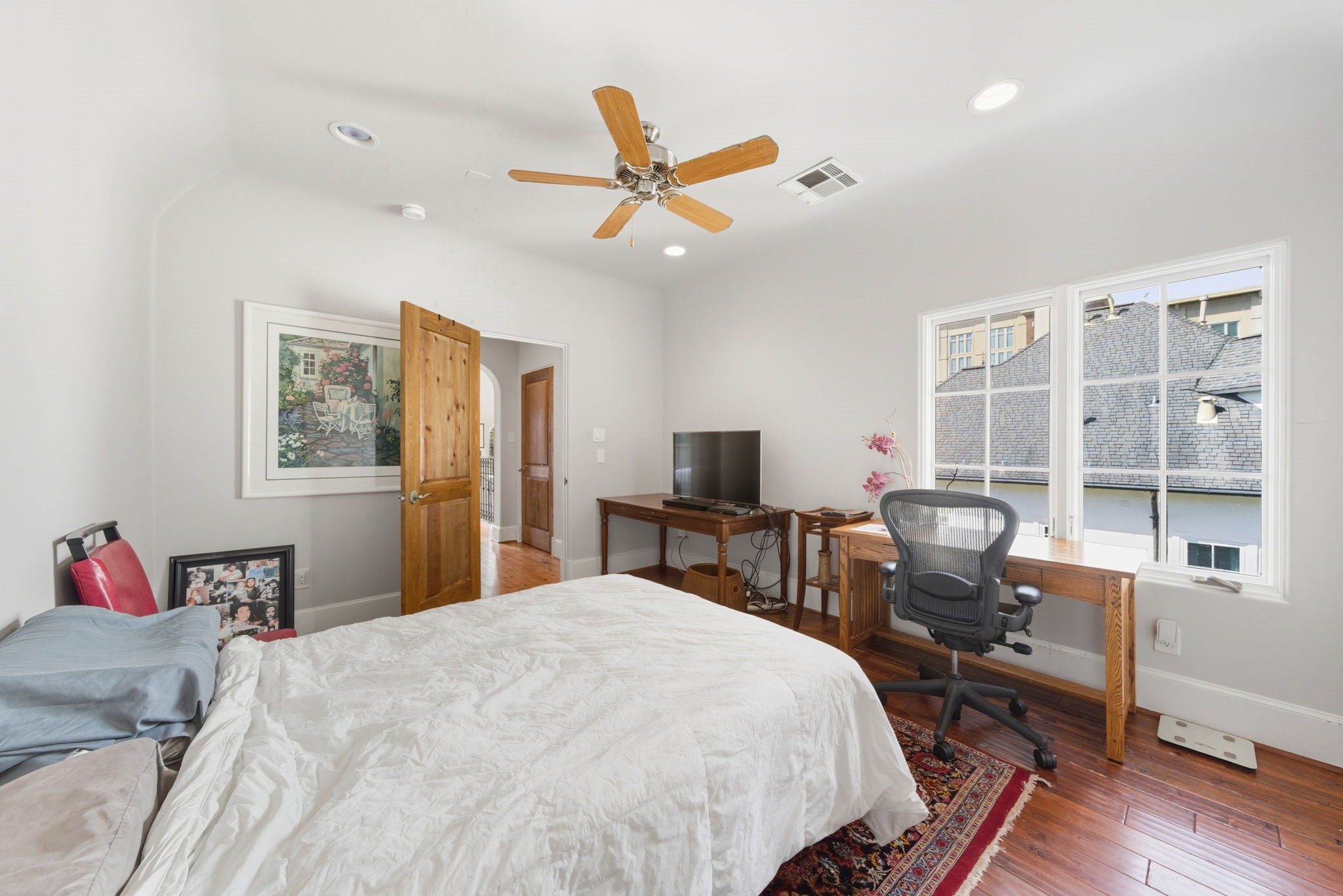 2370 Bolsover Street Houston, TX 77005 - Photo 32 of 46 a bedroom with a bed and wooden floor