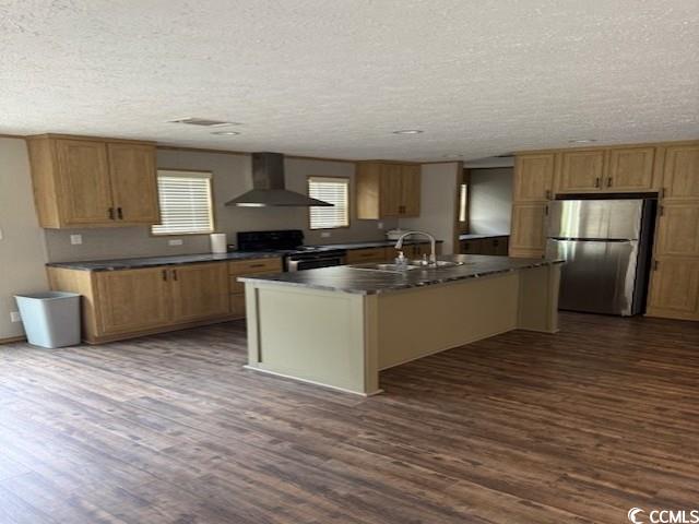 65 Clemmons Drive Tabor City, NC 28463 - Photo 9 of 29 Kitchen with stainless steel appliances, wall chimney exhaust hood, dark wood-type flooring, dark countertops, and a textured ceiling