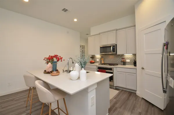 a kitchen with a sink stainless steel appliances and cabinets