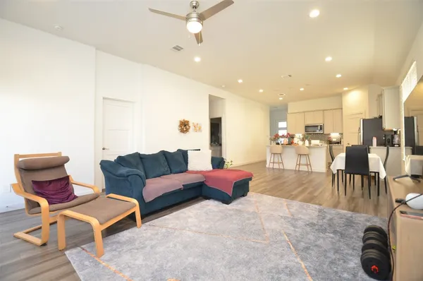 a living room with furniture and kitchen view