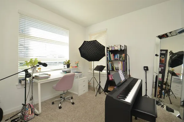 a view of a workspace with furniture and a window