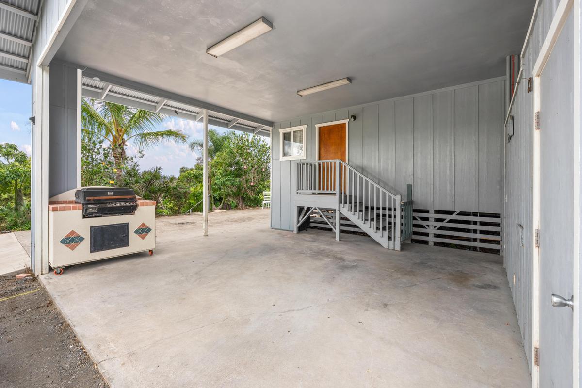 92-8583 Paradise Parkway Ocean View, HI 96704 - Photo 17 of 28 a view of a livingroom with furniture wooden floor and window
