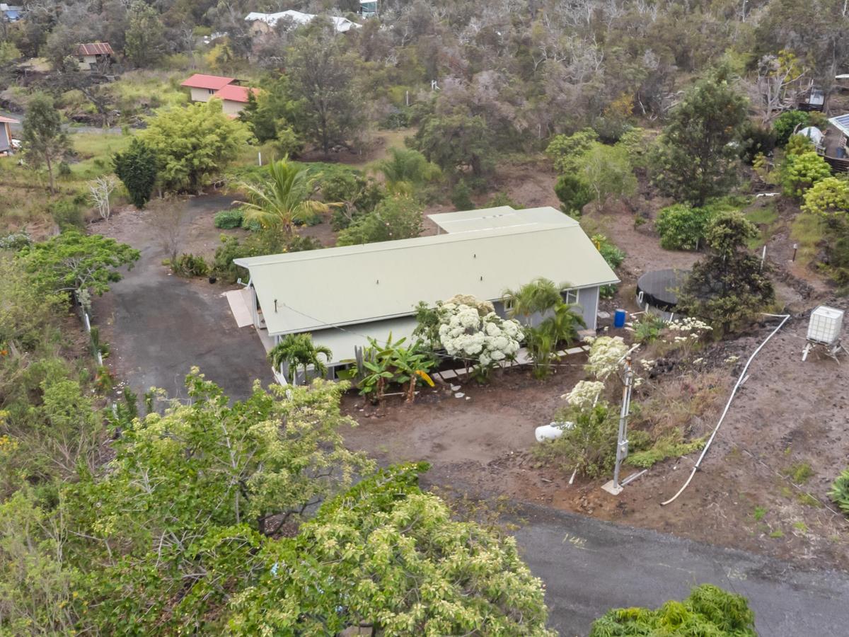 92-8583 Paradise Parkway Ocean View, HI 96704 - Photo 21 of 28 an outdoor space with plants and trees
