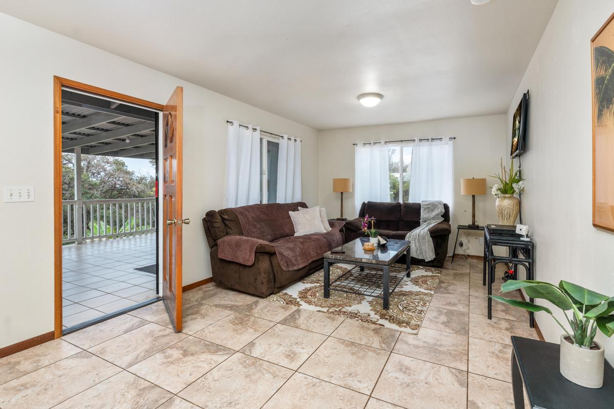 92-8583 Paradise Parkway Ocean View, HI 96704 - Photo 3 of 28 a living room with furniture and a potted plant
