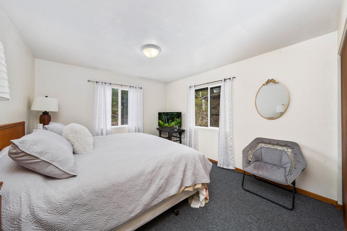 92-8583 Paradise Parkway Ocean View, HI 96704 - Photo 10 of 28 a bedroom with bed and a window