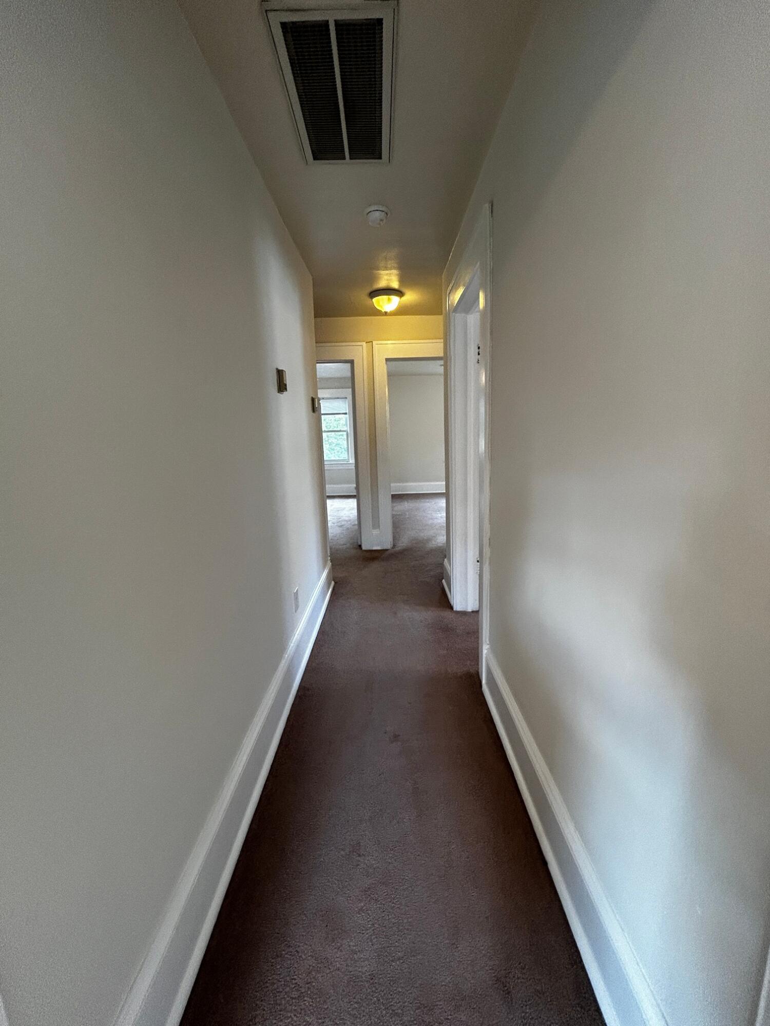 1912 Arden Road Southwest Roanoke, VA 24015 - Photo 18 of 19 a view of a hallway with wooden floor and a bathroom