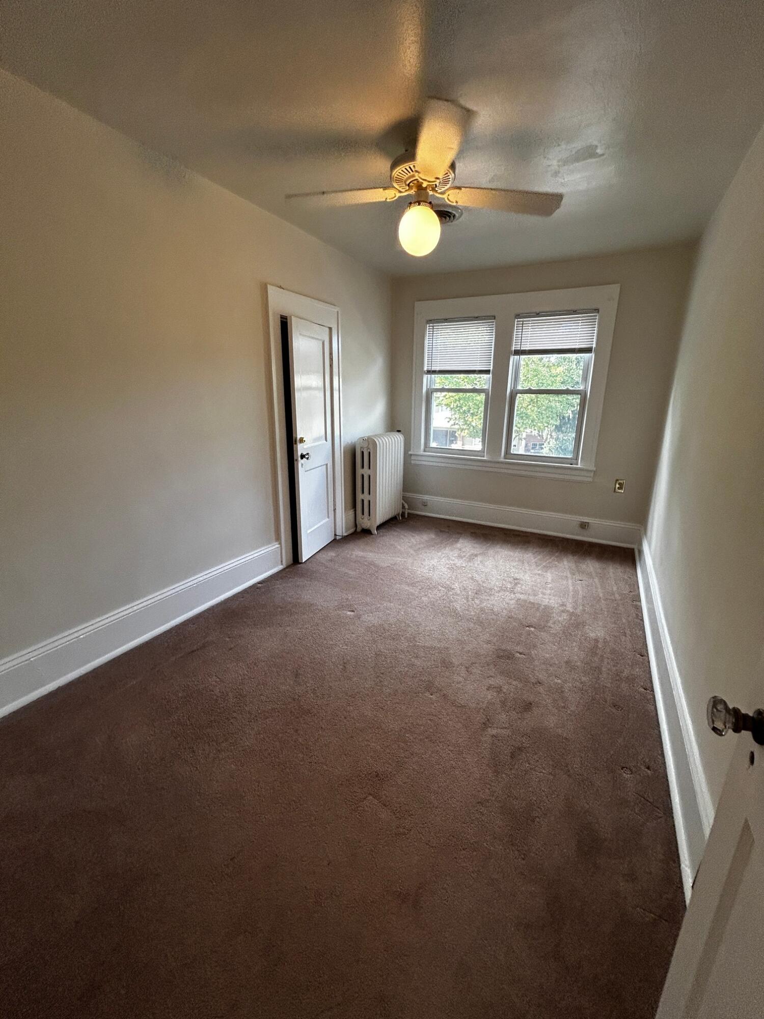 1912 Arden Road Southwest Roanoke, VA 24015 - Photo 4 of 19 an empty room with windows and fan