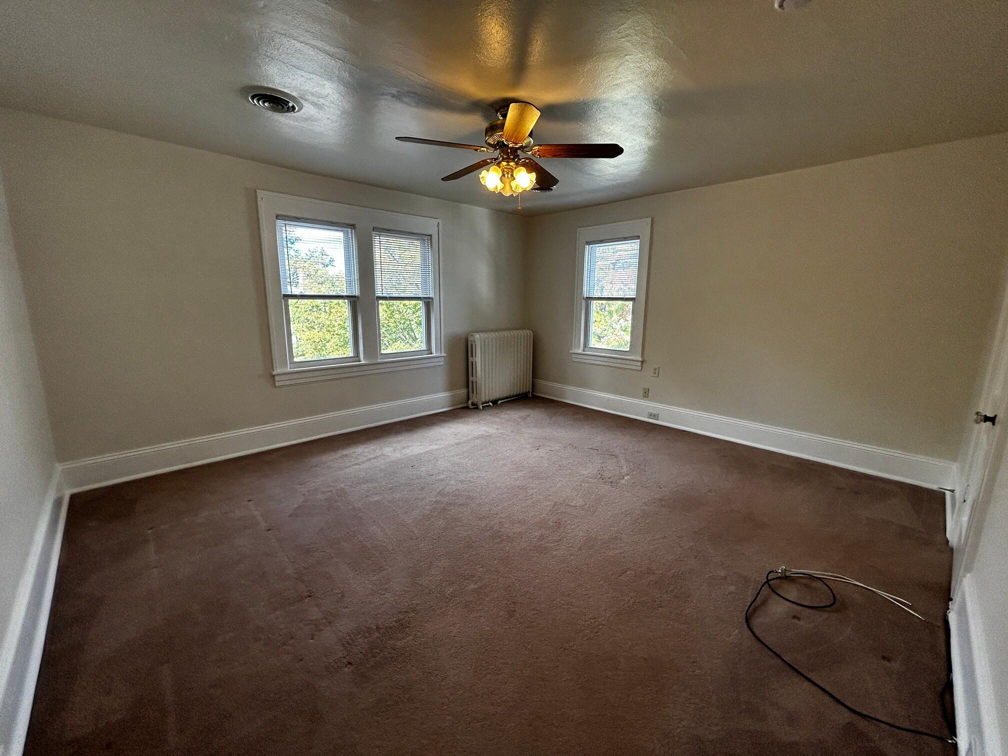 1912 Arden Road Southwest Roanoke, VA 24015 - Photo 9 of 19 an empty room with windows and ceiling fan