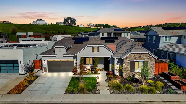 a front view of a house with garden