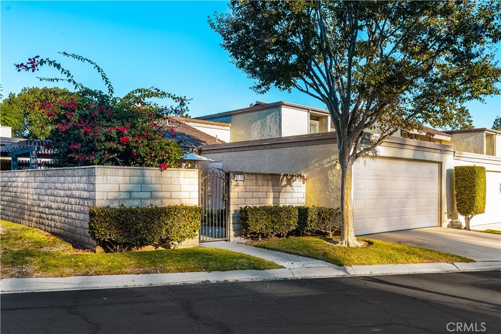 5573 East Vista Del Rio Anaheim, CA 92807 - Photo 2 of 42 a front view of a house with a yard and garage