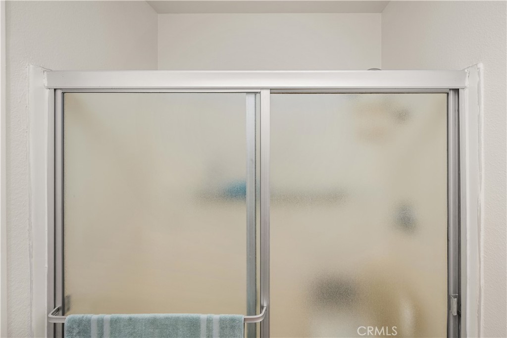 5573 East Vista Del Rio Anaheim, CA 92807 - Photo 23 of 42 a bathroom with a glass shower door