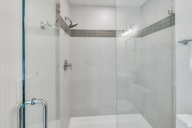 3813 North Foothill Drive Provo, UT 84604 - Photo 27 of 71 Glass-enclosed shower featuring a handheld showerhead and wall-mounted controls