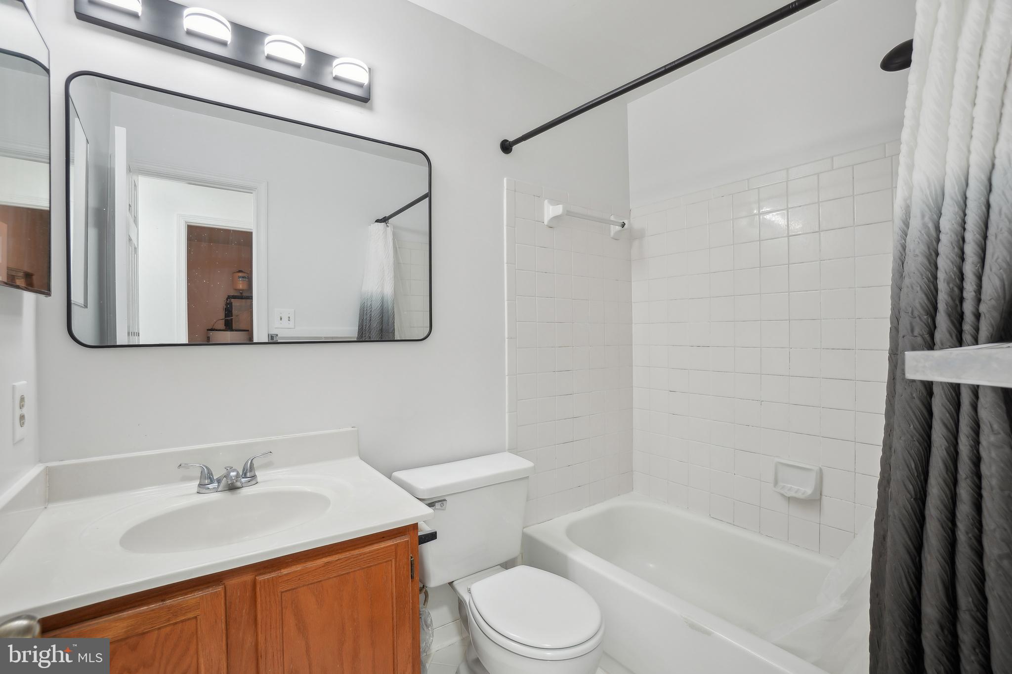 3425 Epic Gate Bowie, MD 20716 - Photo 21 of 25 a bathroom with a granite countertop sink toilet a mirror and bathtub
