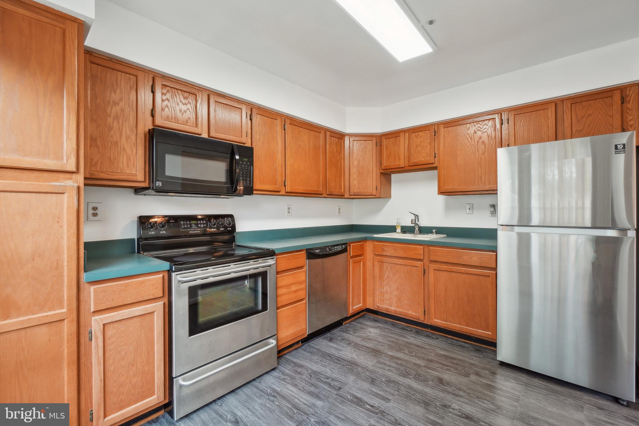 3425 Epic Gate Bowie, MD 20716 - Photo 9 of 25 a kitchen with wooden cabinets and stainless steel appliances