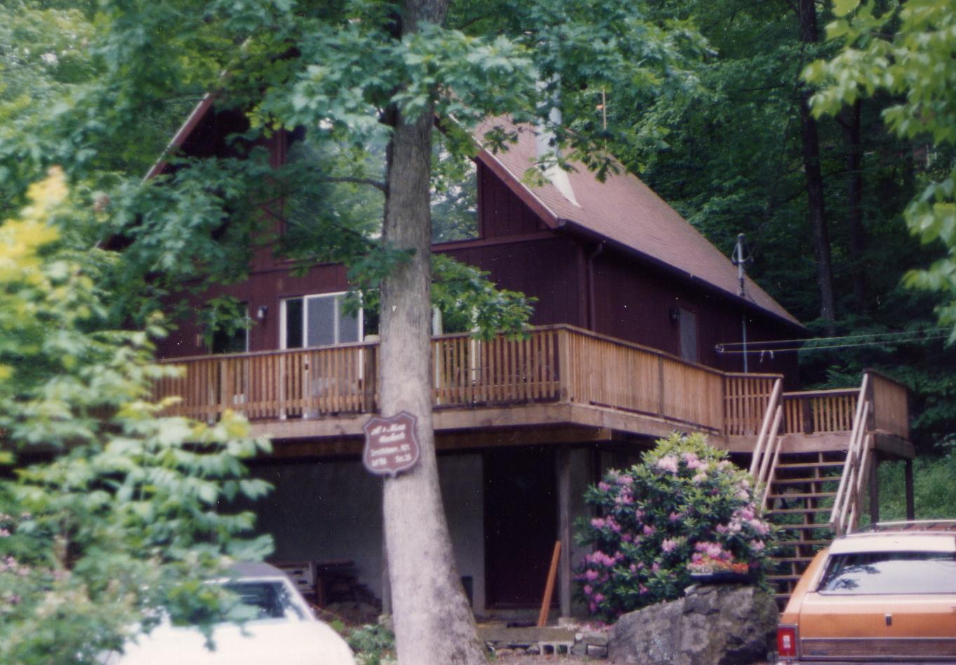 86 Cherry Ridge Road Bushkill, PA 18324 - Photo 1 of 1 a view of a house with a small yard plants and large tree
