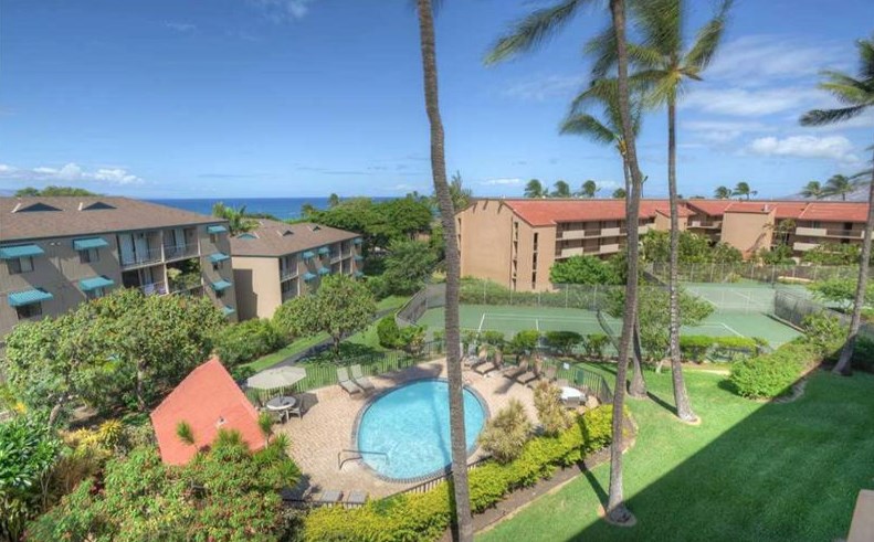 2191 South Kihei Road, Unit 2405 Kihei, HI 96753 - Photo 12 of 17 a backyard of a house with table and chairs under an umbrella