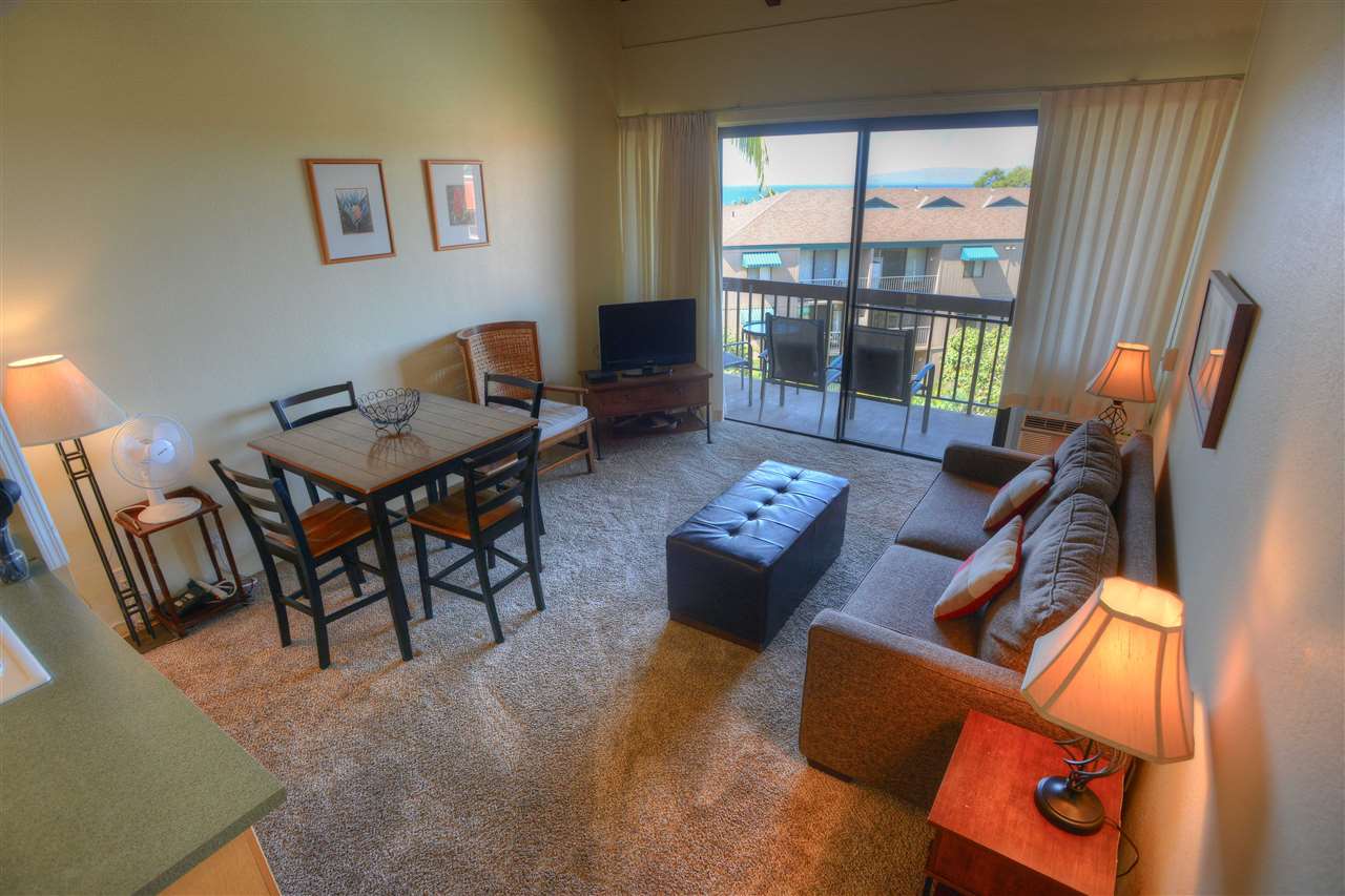2191 South Kihei Road, Unit 2405 Kihei, HI 96753 - Photo 2 of 17 a living room with furniture and a floor to ceiling window