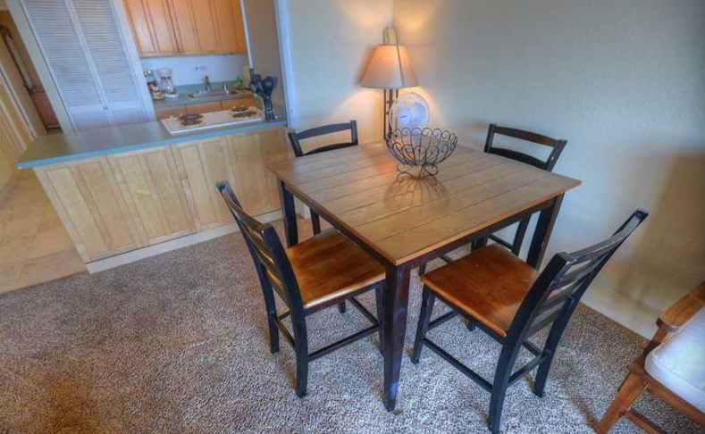 2191 South Kihei Road, Unit 2405 Kihei, HI 96753 - Photo 5 of 17 a view of a dining room with furniture and a lamp