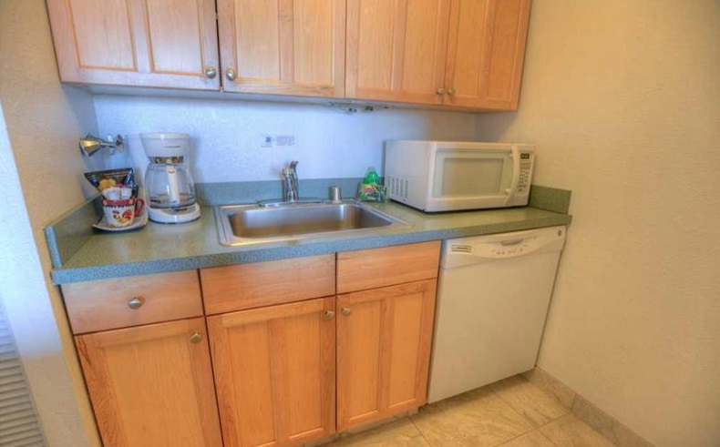 2191 South Kihei Road, Unit 2405 Kihei, HI 96753 - Photo 7 of 17 a kitchen with stainless steel appliances granite countertop white cabinets and a sink