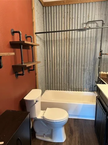 a bathroom with a sink a toilet and bathtub