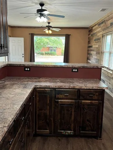 a kitchen with granite countertop a stove and a sink