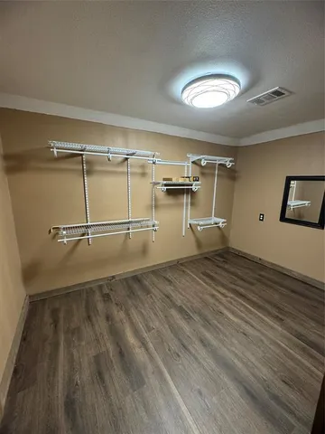 a view of a room with wooden floor