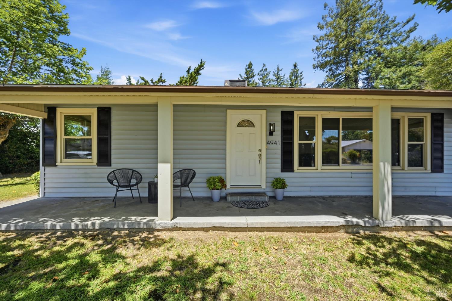4941 Hansen Drive Santa Rosa, CA 95409 - Photo 3 of 35 Relax on your wide front porch and enjoy the summer breeze rustling the leaves of the twin sycamore trees in your front yard
