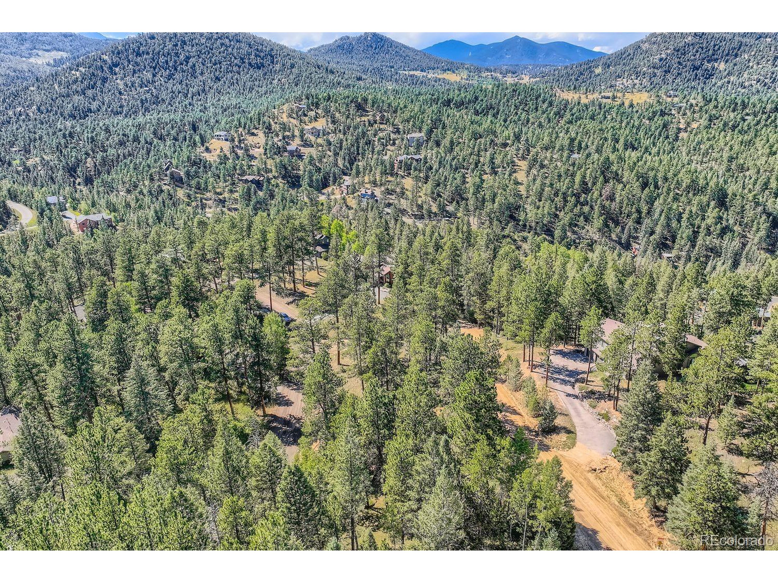 7000 Blue Creek Road Evergreen, CO 80439 - Photo 5 of 11 a view of a lush green field